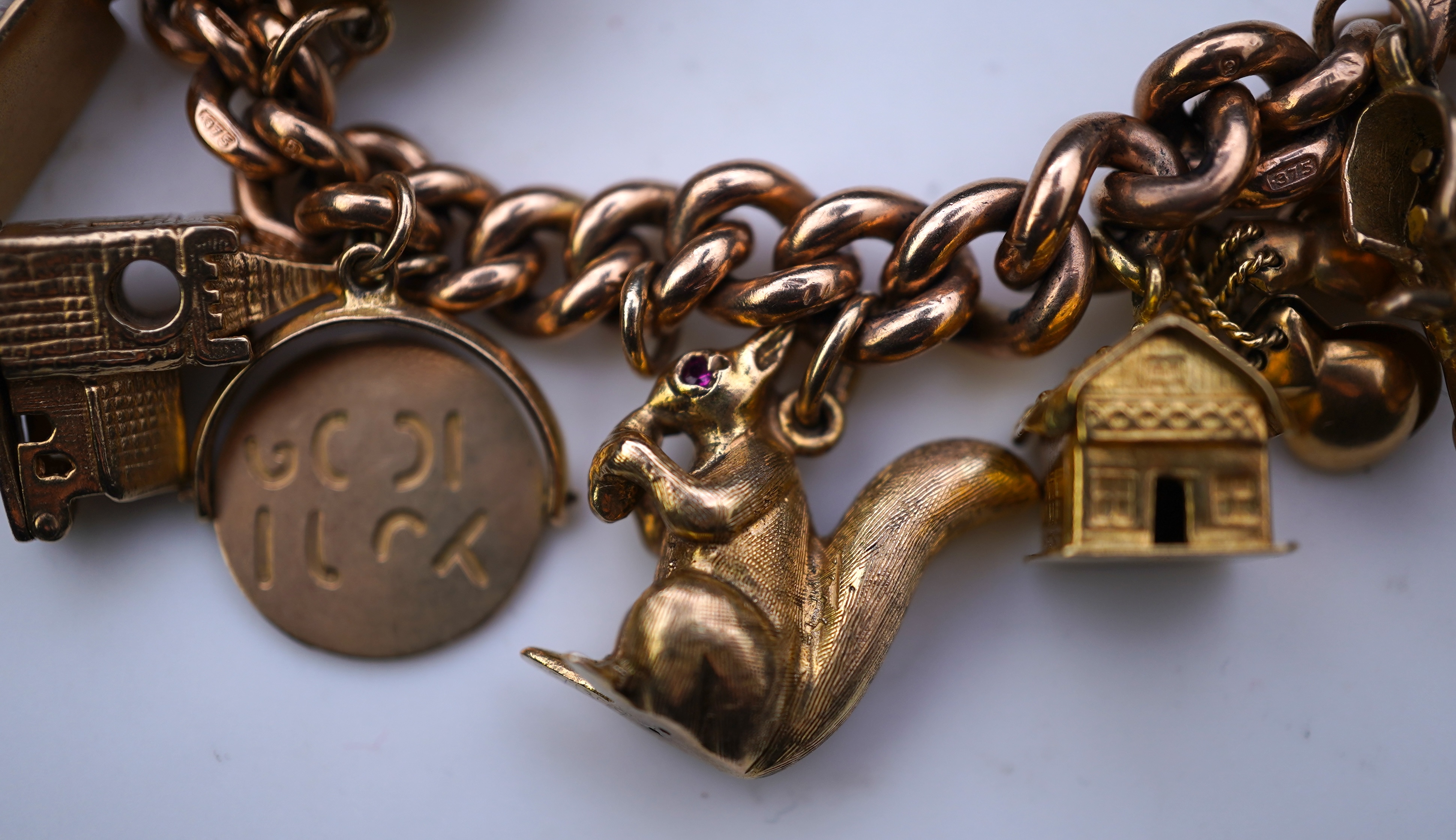 A 9ct gold charm bracelet, mid 20th century